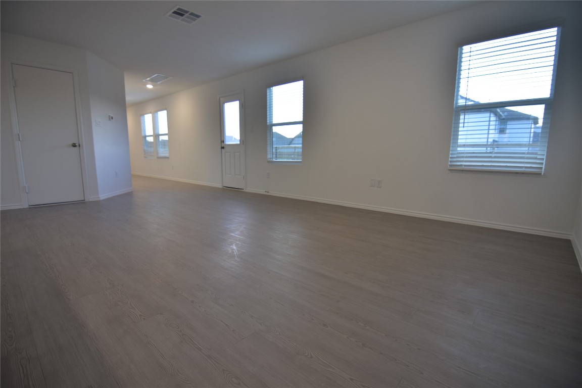 343 Keefer Kyle, TX 78640 - Photo 7 of 38 Unfurnished room featuring baseboards and dark wood finished floors