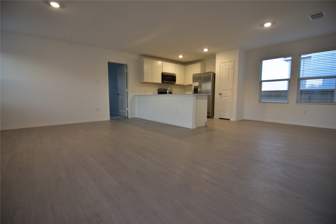 343 Keefer Kyle, TX 78640 - Photo 38 of 38 Kitchen featuring open floor plan, white cabinetry, recessed lighting, dark wood-type flooring, and appliances with stainless steel finishes