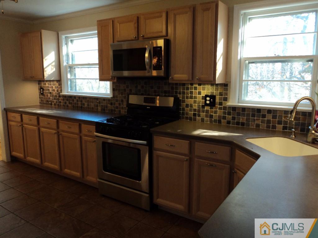 515 Sutherland Road Ewing, NJ 08618 - Photo 11 of 25 a kitchen with granite countertop a sink window and microwave