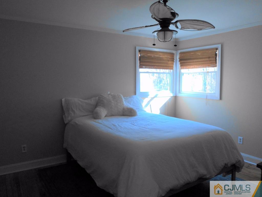 515 Sutherland Road Ewing, NJ 08618 - Photo 15 of 25 a bedroom with a bed and a chandelier