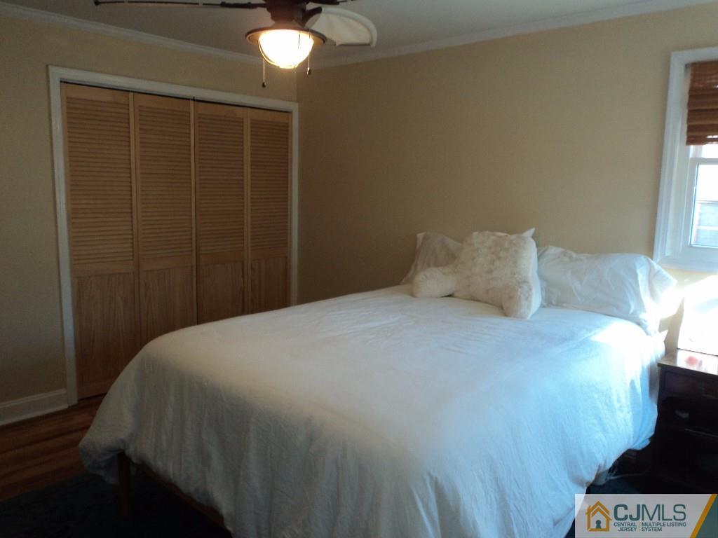 515 Sutherland Road Ewing, NJ 08618 - Photo 16 of 25 a bedroom with a bed and a chandelier fan