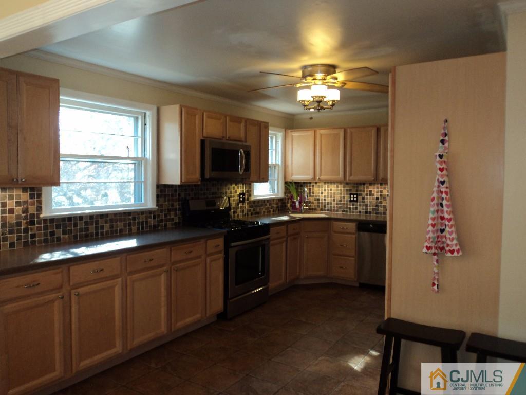 515 Sutherland Road Ewing, NJ 08618 - Photo 9 of 25 a kitchen with a sink stove and microwave