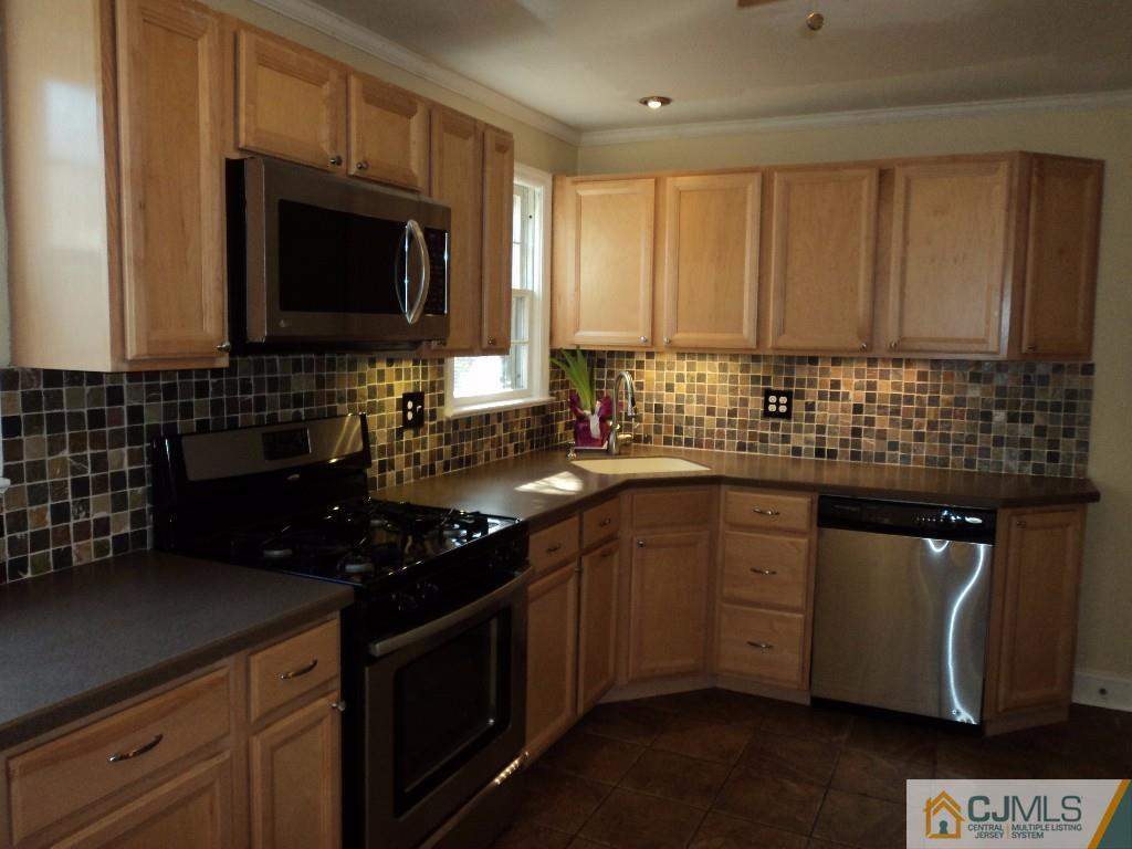 515 Sutherland Road Ewing, NJ 08618 - Photo 10 of 25 a kitchen with stainless steel appliances a sink stove and microwave