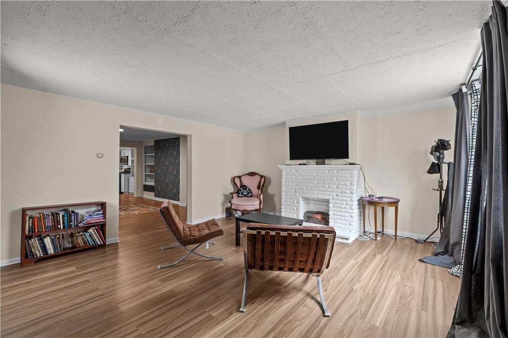 115 Frederick Street Mount Oliver, PA 15210 - Photo 2 of 35 a living room with furniture and a flat screen tv