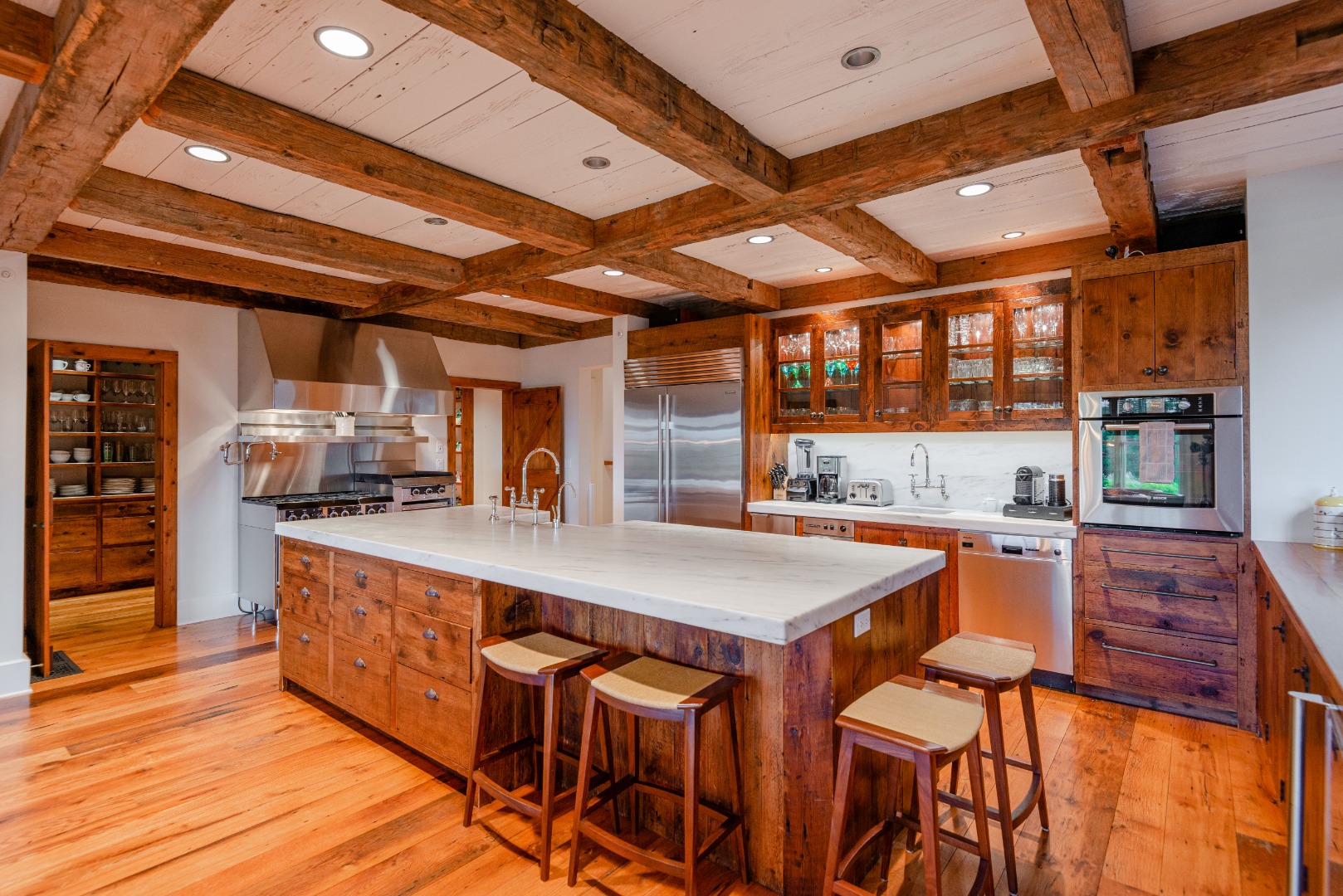 183 Polpis Road Nantucket, MA 02554 - Photo 20 of 62 a large kitchen with a table and chairs in it