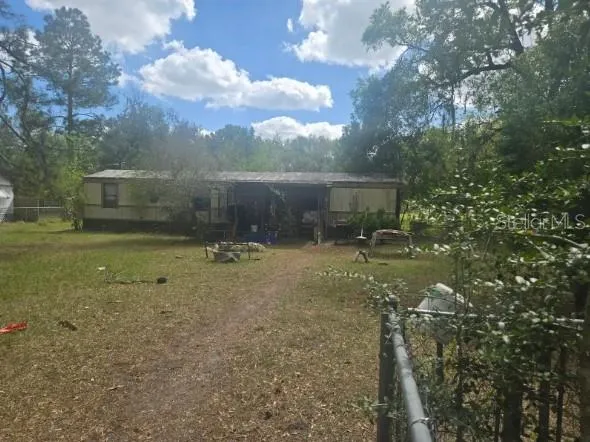 a view of a house with a backyard