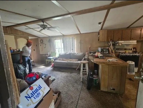 a living room with furniture and a gym
