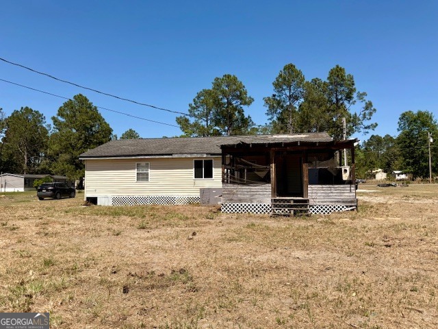 721 Ronnie Street Metter, GA 30439 - Photo 16 of 18 a front view of a house with a yard