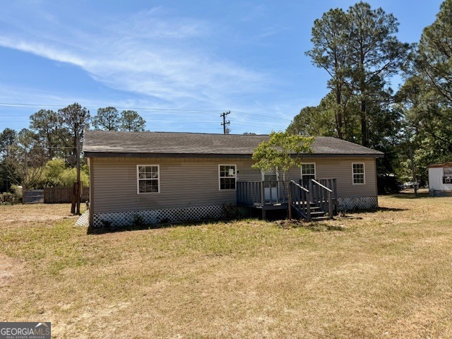 721 Ronnie Street Metter, GA 30439 - Photo 17 of 18 a front view of house with yard and trees in the background