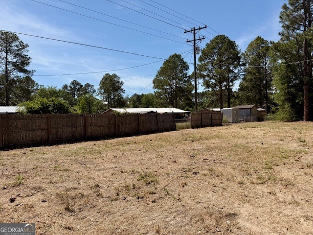 721 Ronnie Street Metter, GA 30439 - Photo 18 of 18 a view of a backyard of the house