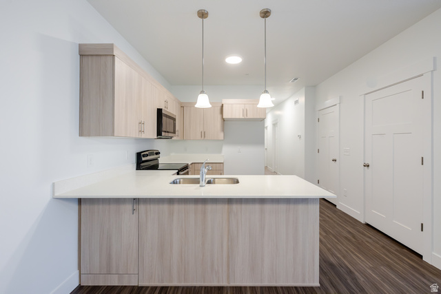 709 West 4500th South, Unit N302 Mapleton, UT 84664 - Photo 11 of 15 Kitchen with light wood finish cabinetry, a peninsula, pendant lighting, stainless steel appliances, and dark wood-style flooring