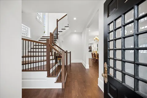 a view of entryway and hall with wooden floor