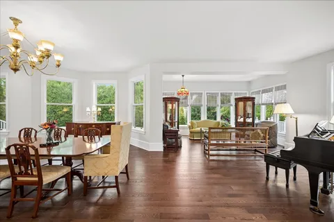 a living room with fireplace furniture and a large window
