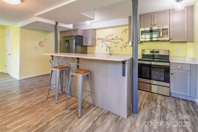 a kitchen with a refrigerator and a wooden cabinets