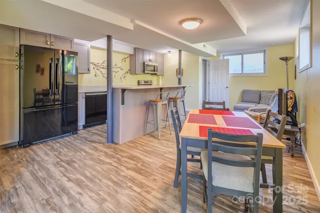 a view of a dining room with furniture and wooden floor