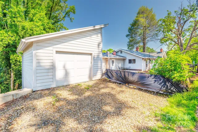a view of a house with a yard and potted plants