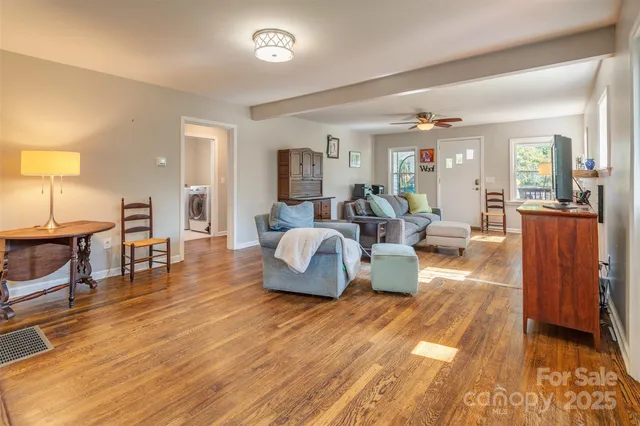 a living room with furniture and a wooden floor