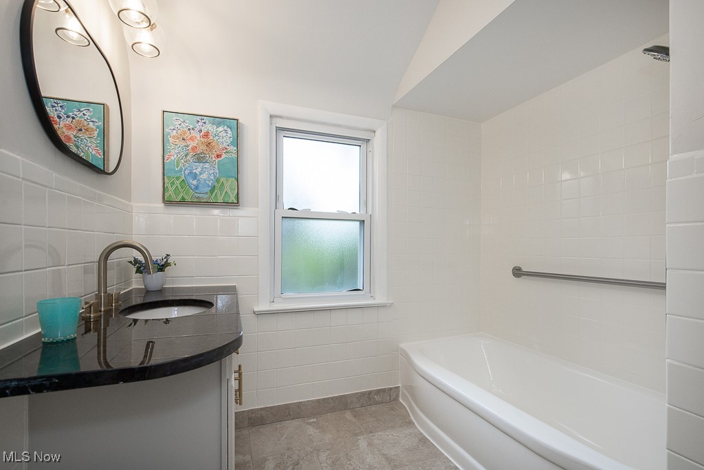 3762 Covington Road South Euclid, OH 44121 - Photo 23 of 31 Bathroom featuring tile walls, vanity, and wainscoting