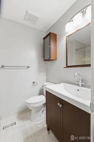 a bathroom with a sink a toilet and mirror
