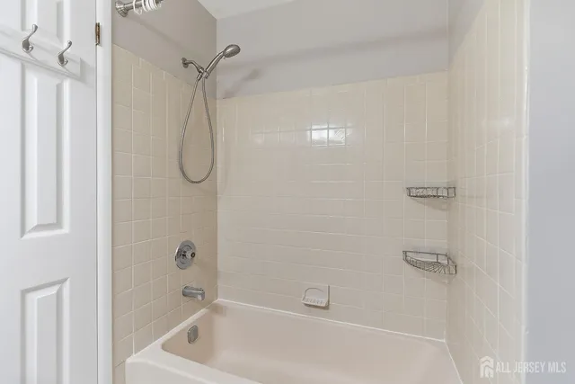 a bathroom with a bath tub with a shower