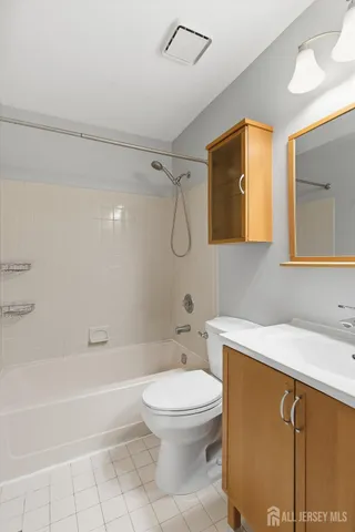 a bathroom with a toilet a sink and bathtub