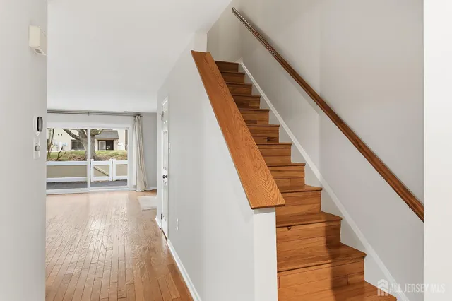 a view of an entryway with wooden floor and stairs