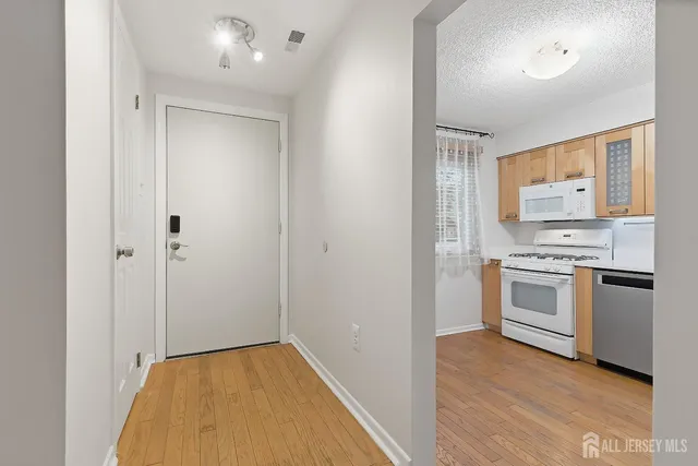 a view of kitchen with sink and stainless steel appliances