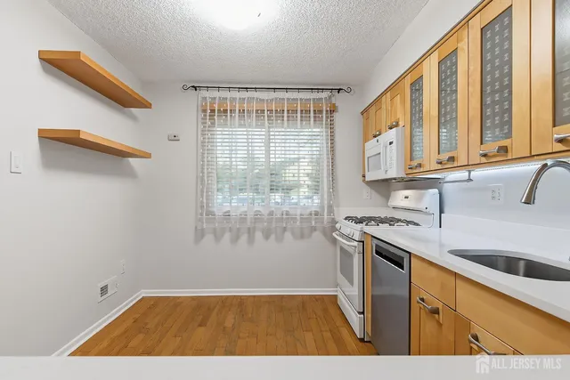 a kitchen with a sink a stove and cabinets
