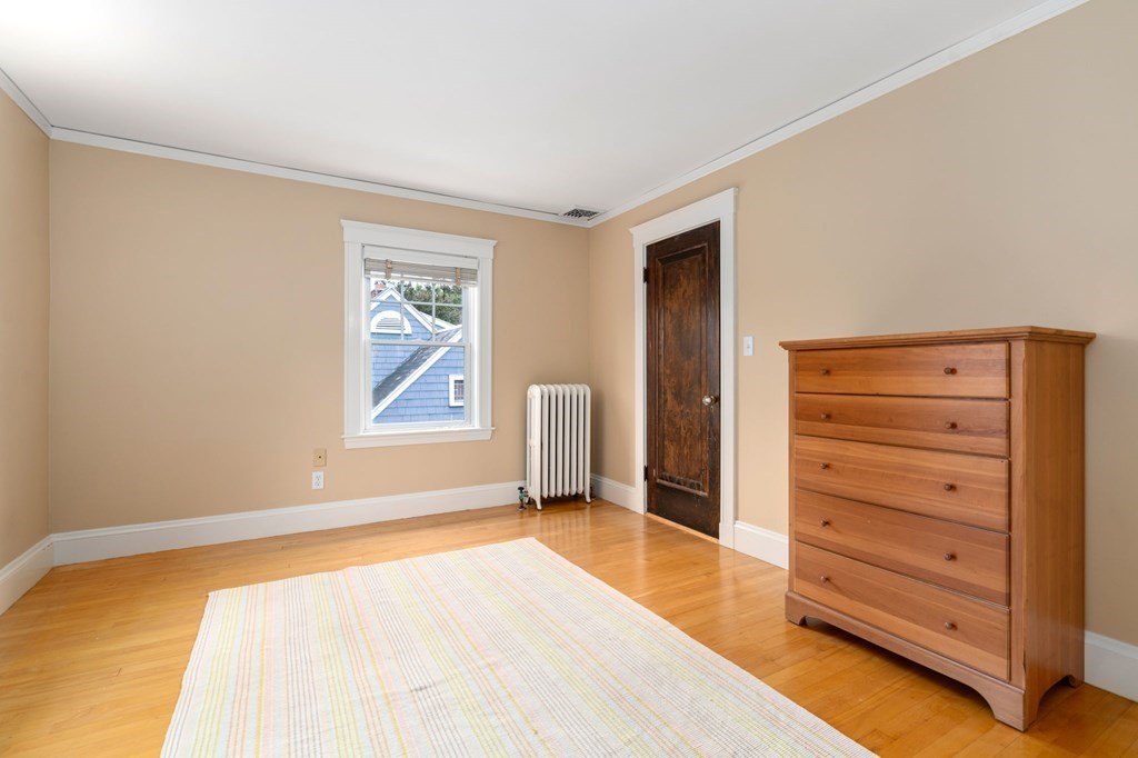66 Stevens Road Needham, MA 02492 - Photo 20 of 33 a bedroom with a bed and a dresser