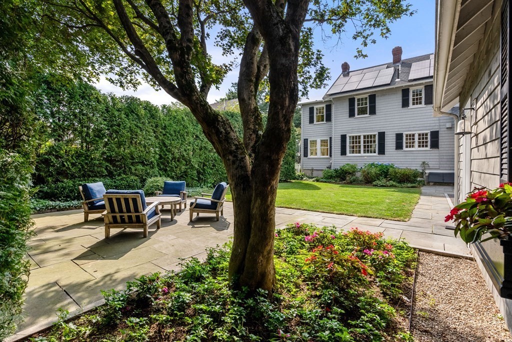 66 Stevens Road Needham, MA 02492 - Photo 25 of 33 a view of a patio with table and chairs potted plants and large tree