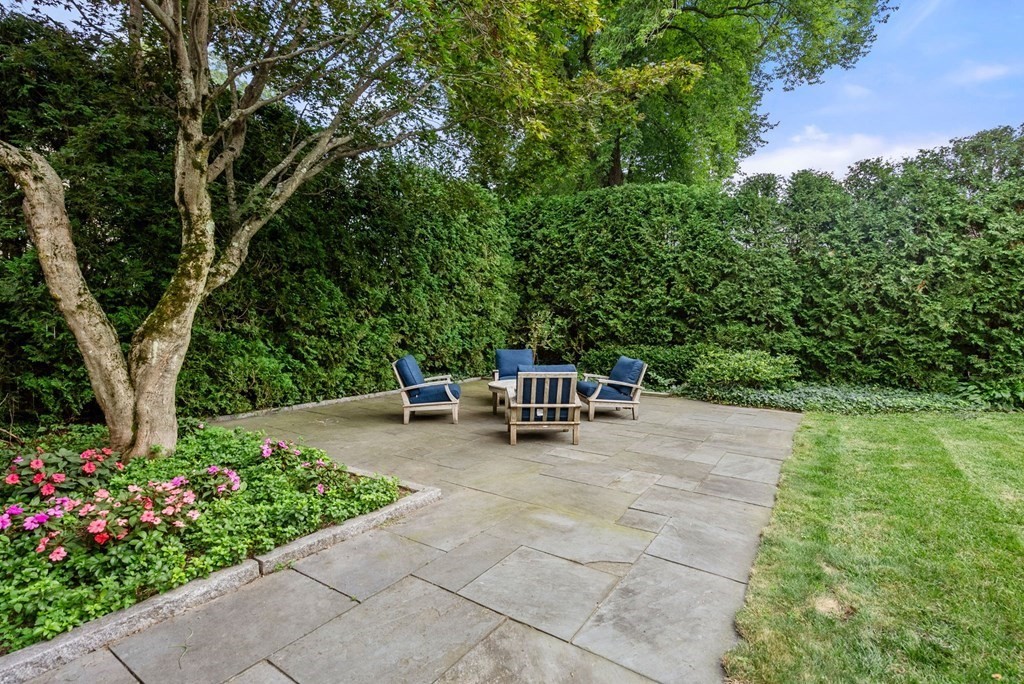 66 Stevens Road Needham, MA 02492 - Photo 27 of 33 a view of a garden with chairs and potted plants
