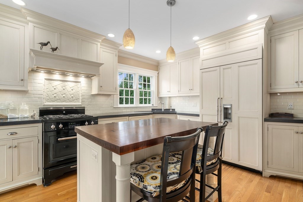 66 Stevens Road Needham, MA 02492 - Photo 5 of 33 a kitchen with stainless steel appliances granite countertop a stove a sink a microwave a center island and a refrigerator