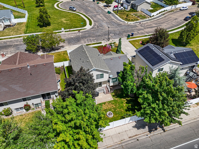 142 East 2675th Street South Clearfield, UT 84015 - Photo 41 of 49 Aerial perspective showcasing a residential property with an expansive backyard featuring a manicured lawn and mature trees