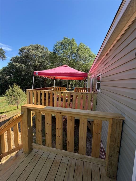 2606 Whipporwill Road Royston, GA 30662 - Photo 17 of 30 a view of a house with wooden deck and furniture