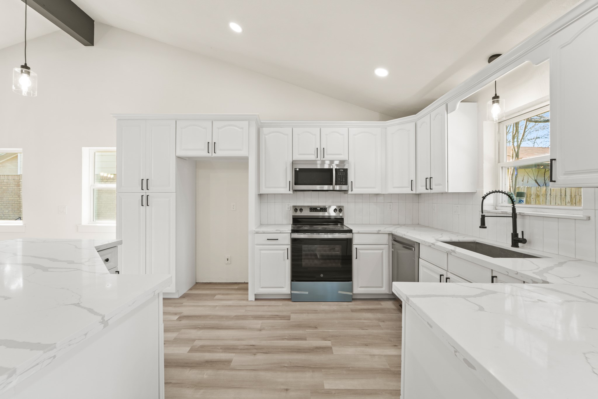 13102 Maxim Drive Houston, TX 77065 - Photo 11 of 45 a kitchen with stainless steel appliances granite countertop a refrigerator sink and white cabinets