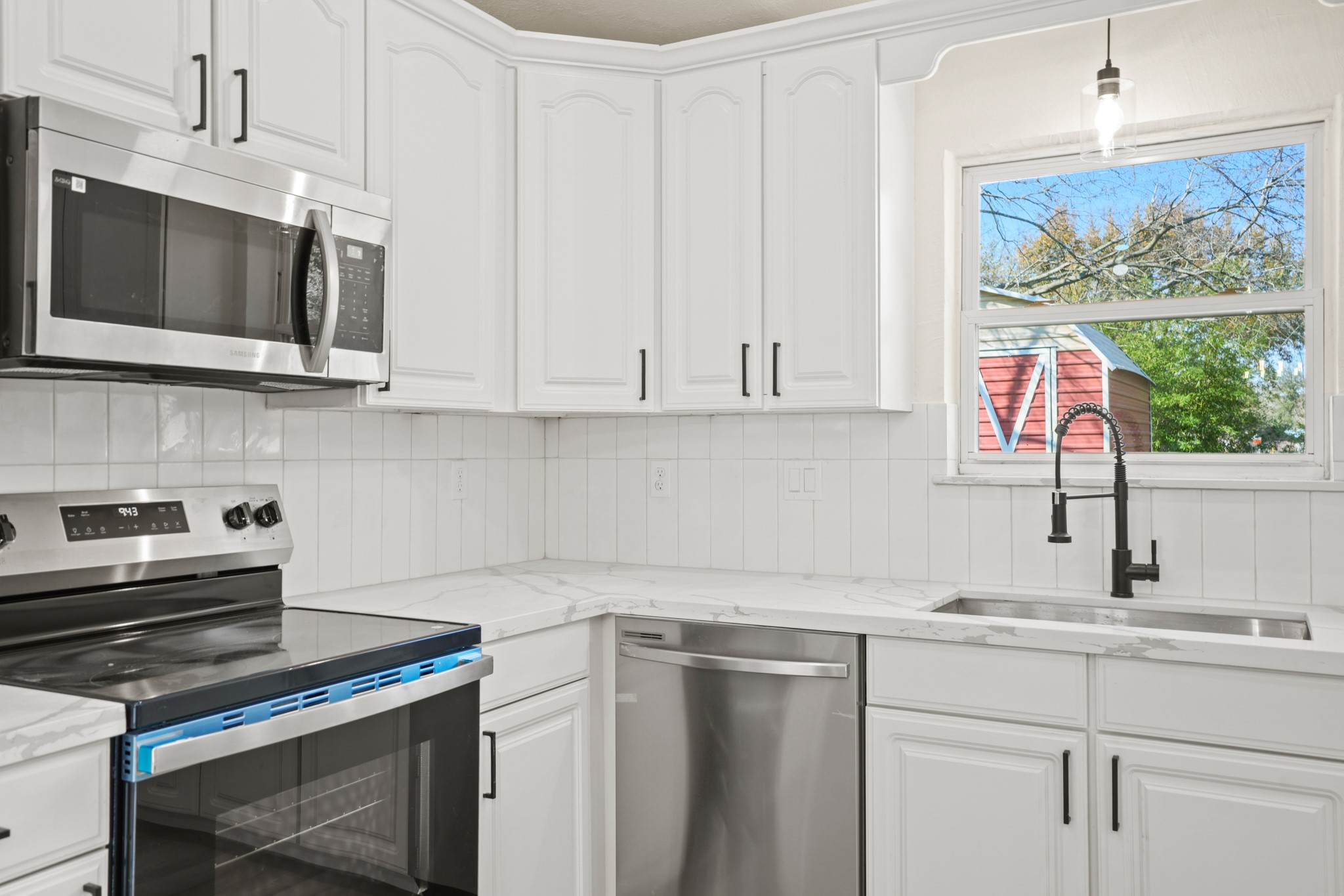 13102 Maxim Drive Houston, TX 77065 - Photo 12 of 45 a kitchen with stainless steel appliances granite countertop a sink and a microwave