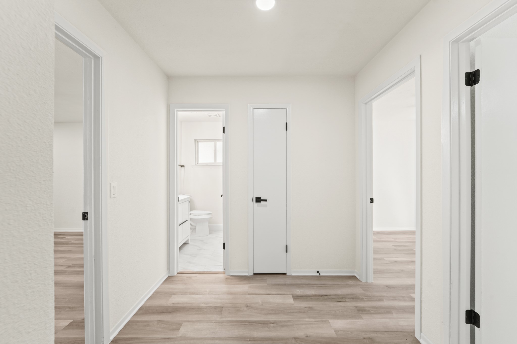 13102 Maxim Drive Houston, TX 77065 - Photo 22 of 45 a view of a hallway with wooden floor and staircase