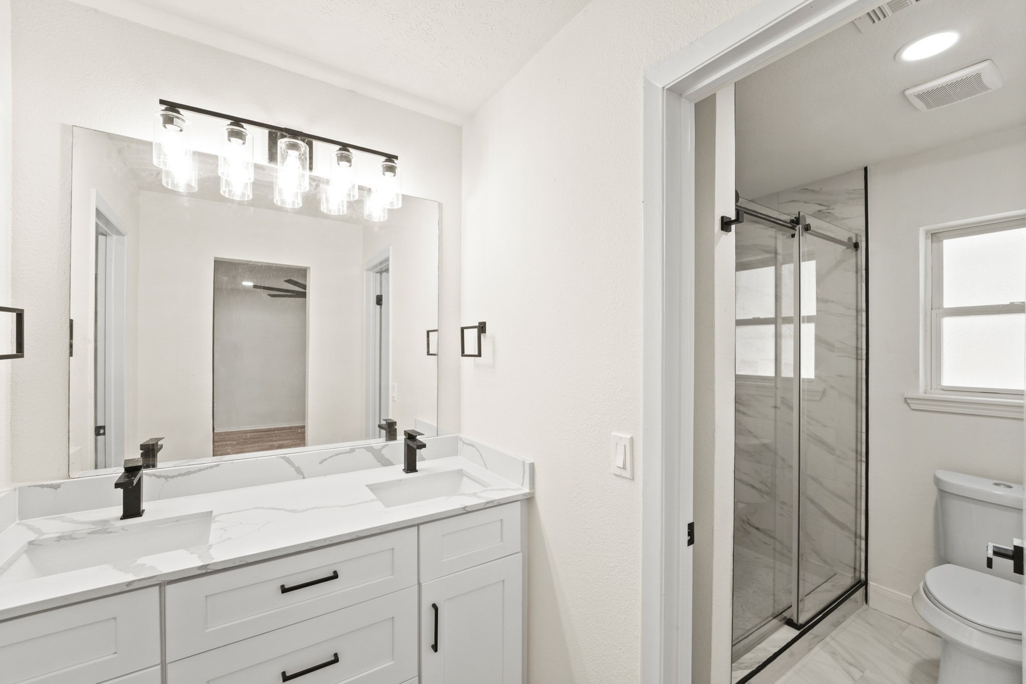 13102 Maxim Drive Houston, TX 77065 - Photo 29 of 45 a bathroom with a granite countertop sink toilet and shower