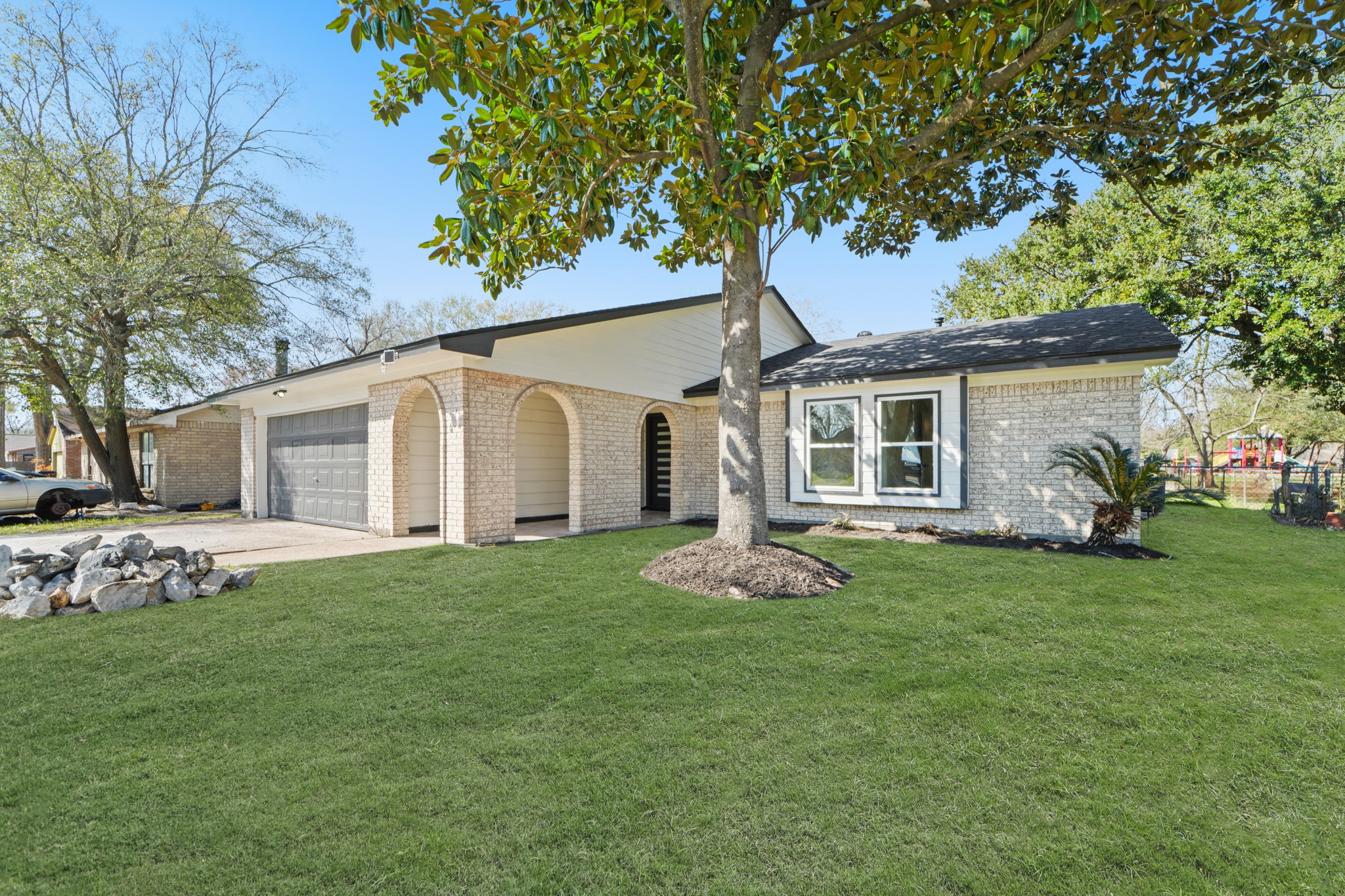 13102 Maxim Drive Houston, TX 77065 - Photo 43 of 45 a front view of a house with a garden
