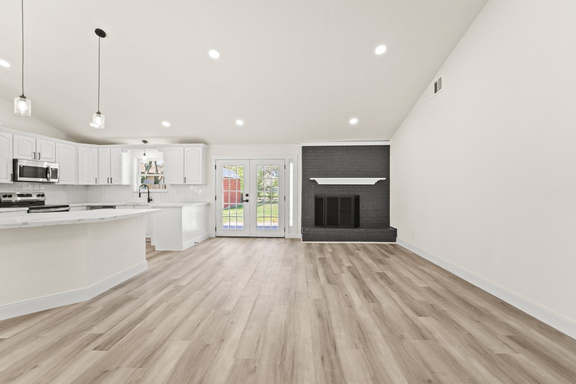 13102 Maxim Drive Houston, TX 77065 - Photo 5 of 45 a large kitchen with kitchen island a sink stainless steel appliances and cabinets