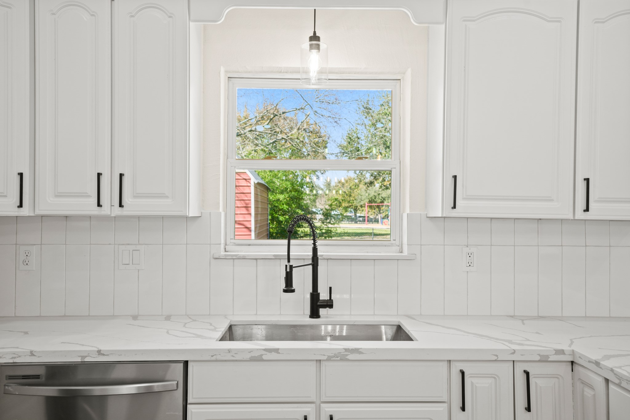13102 Maxim Drive Houston, TX 77065 - Photo 6 of 45 a kitchen with granite countertop white cabinets and a window