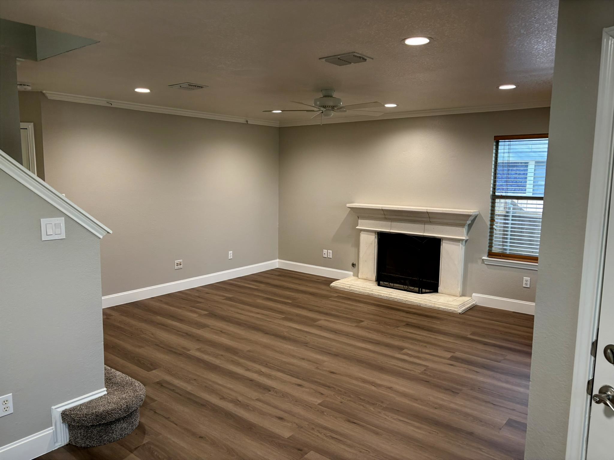 14707 Single Trace Austin, TX 78728 - Photo 8 of 17 A refined living area boasts elegant flooring and a welcoming fireplace, perfect for daily comfort.
