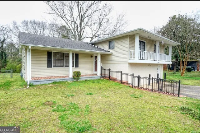 a backyard of a house with table and chairs