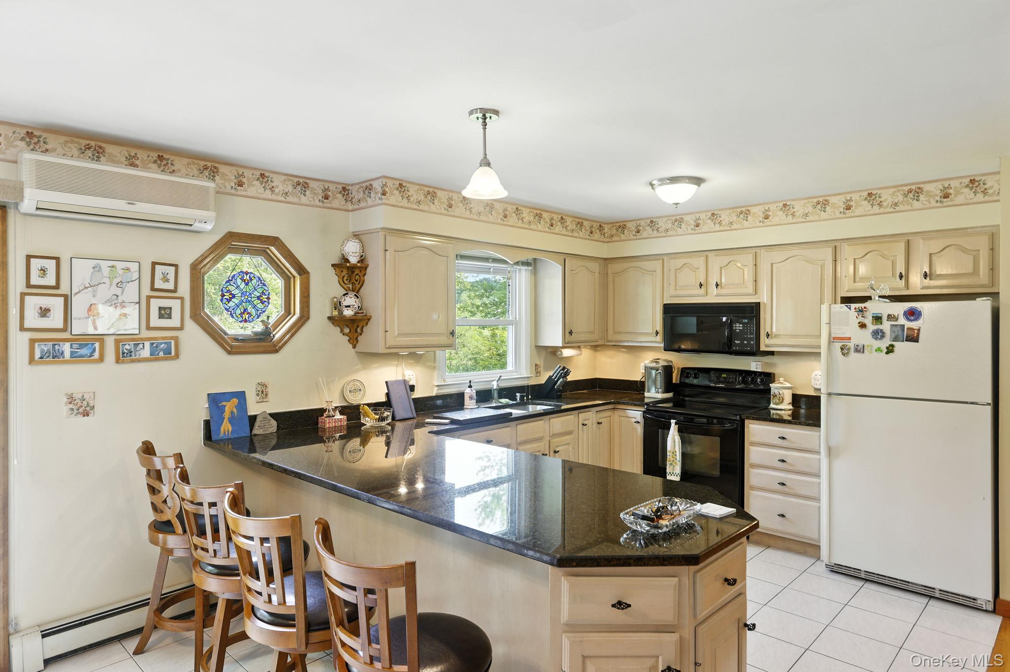 220 North Parliman Road LaGrangeville, NY 12540 - Photo 12 of 41 a kitchen with stainless steel appliances granite countertop a stove top oven a sink a dining table and chairs