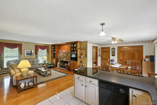 a very nice looking living room with a large window and dining table