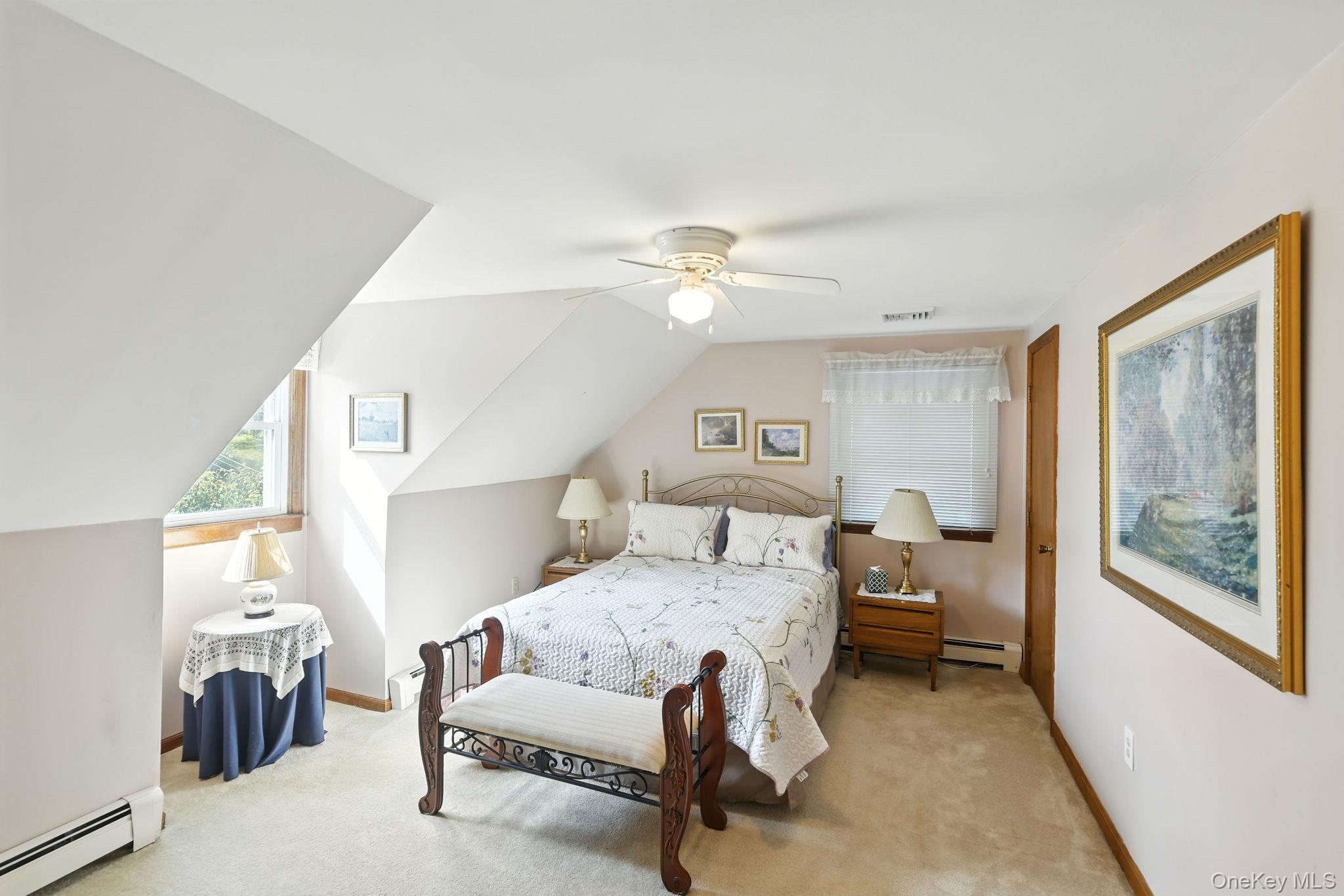 220 North Parliman Road LaGrangeville, NY 12540 - Photo 18 of 41 a bedroom with a bed and a chandelier