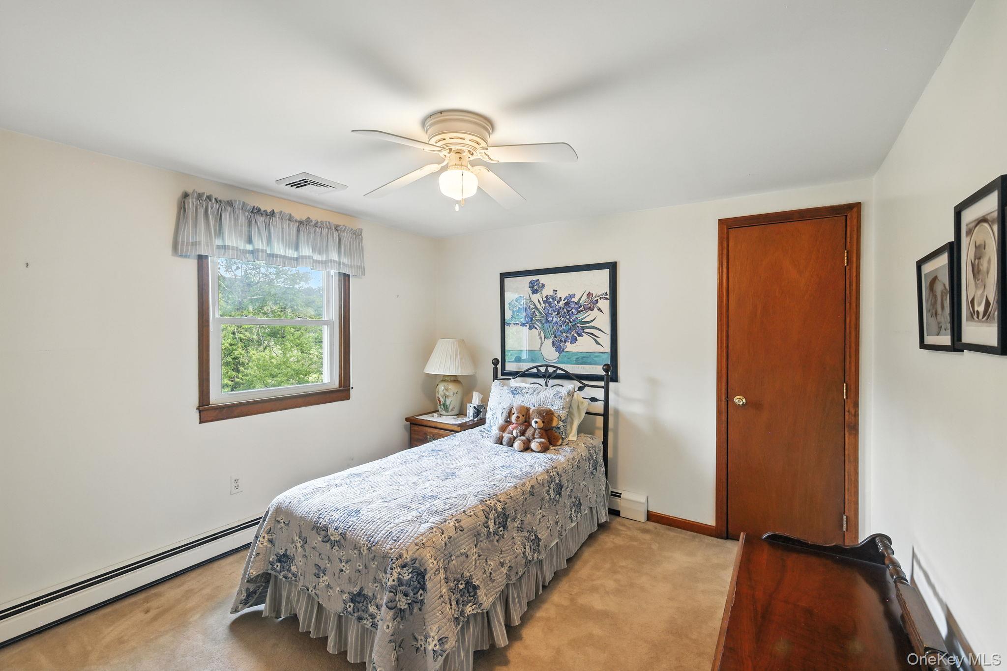 220 North Parliman Road LaGrangeville, NY 12540 - Photo 21 of 41 a bedroom with a bed and a chandelier