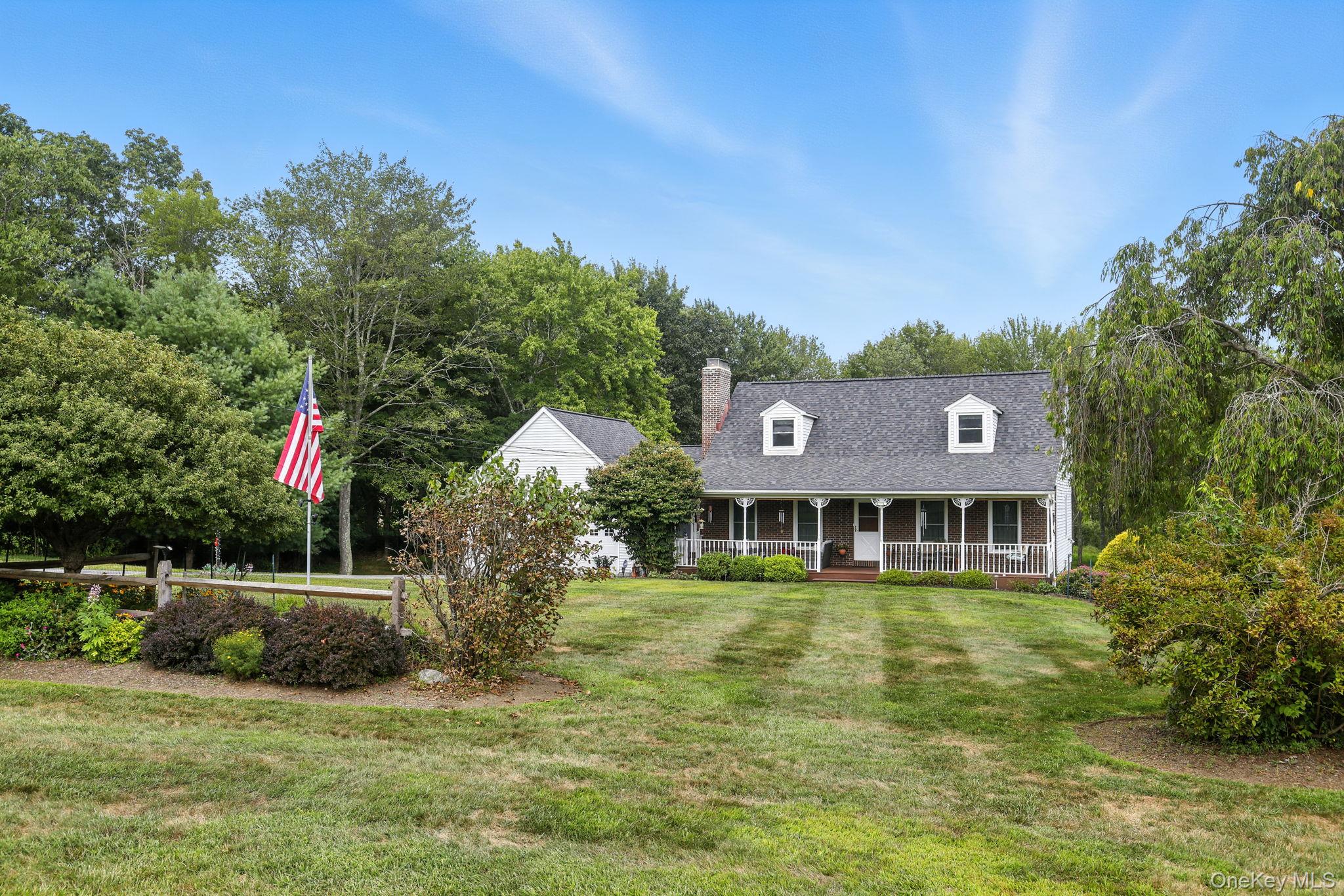 220 North Parliman Road LaGrangeville, NY 12540 - Photo 3 of 41 a front view of a house with a garden and plants