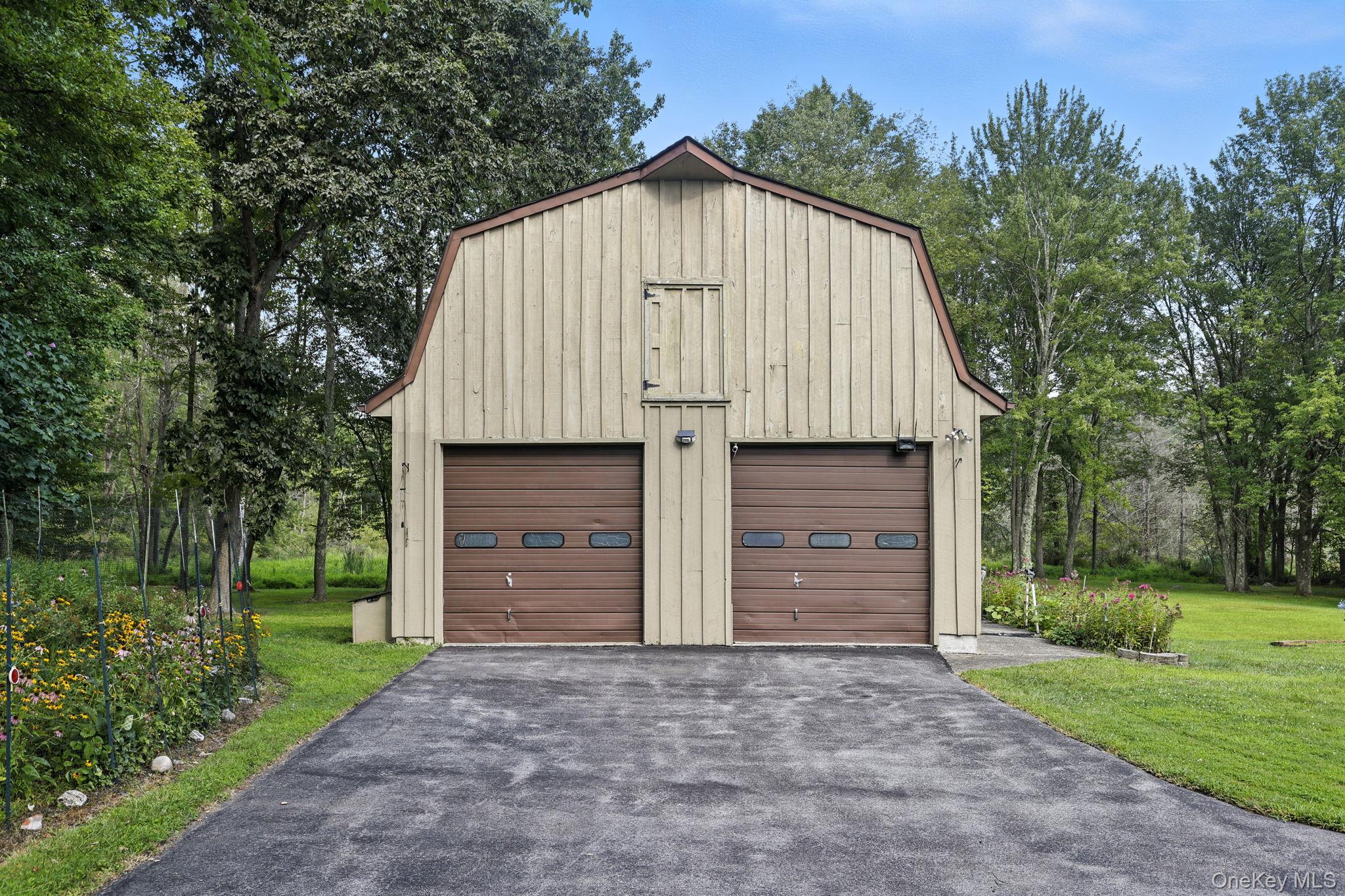 220 North Parliman Road LaGrangeville, NY 12540 - Photo 31 of 41 a view of a small house with a yard and garage