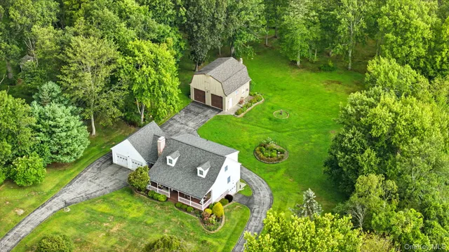 an aerial view of a house with a yard